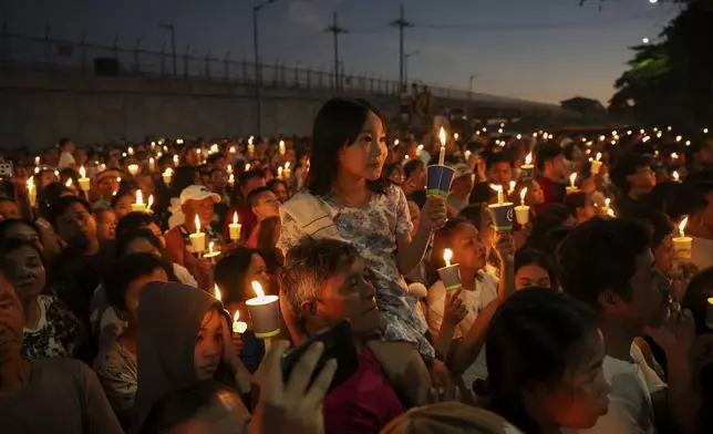 Filipino Catholic devotees light candles as they attend Easter Sunday rites at the St. Peter Chapels in Quezon City, Philippines, Sunday, April 20, 2025. (AP Photo/Basilio Sepe)