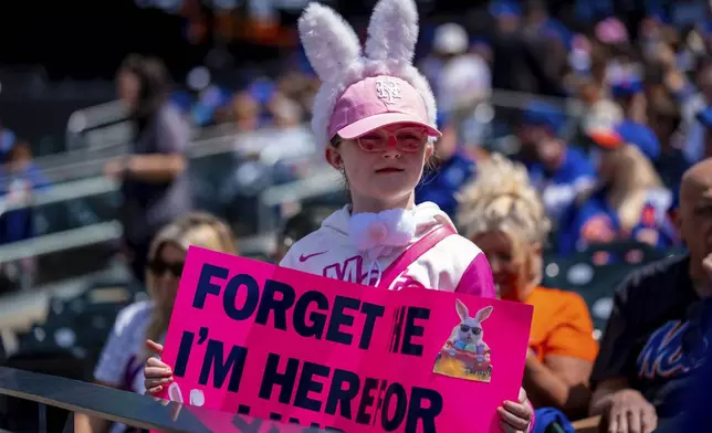 Fans wear bunny ears at the Easter baseball game between the New York Mets and the St. Louis Cardinals, Sunday, April 20, 2025, in New York. (AP Photo/Angelina Katsanis)