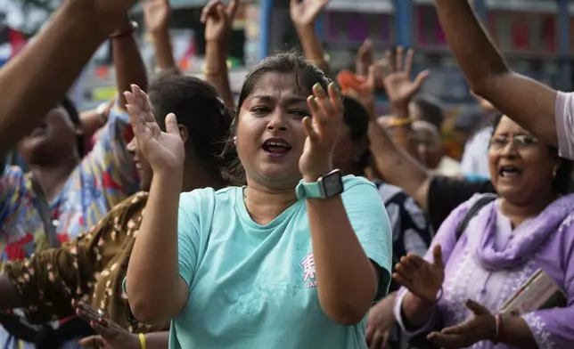 Indian Catholics dance in the street as the walk in a procession celebrating Easter Sunday commemorating the day when according to Christian tradition Jesus was resurrected in Jerusalem two millennia ago, in Kolkata, India, Sunday, April 20, 2025. (AP Photo/Bikas Das)