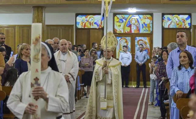 Louis Sako, center, patriarch of Iraq's Chaldean Catholic Church blesses the faithful during attend Easter religious services at Mar Youssif Chaldean Church in Baghdad, Iraq, Saturday, April 19, 2023. (AP Photo/Hadi Mizban)