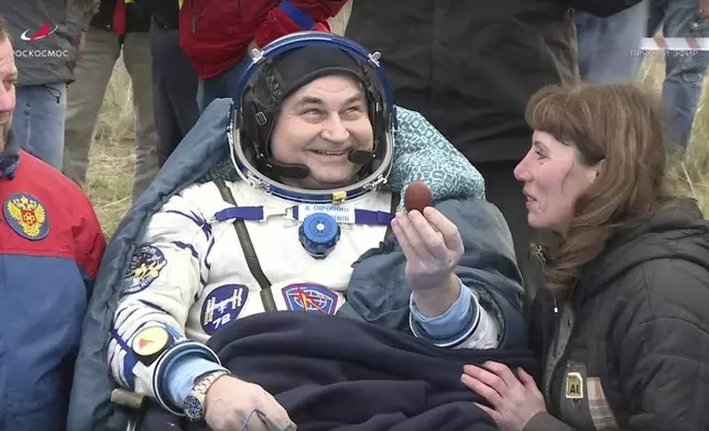 In this photo taken from video released by Roscosmos space corporation Roscosmos cosmonaut Alexey Ovchinin holds traditional Easter painted egg shortly after the landing of the Russian Soyuz MS-26 space capsule with Roscosmos cosmonaut Ivan Vagner and NASA astronaut Don Pettit, near Kazakh town of Zhezkazgan, Kazakhstan, Sunday, April 20, 2025. (Roscosmos space corporation via AP)