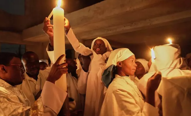Christian faithful of the Legio Maria African Mission, attend the Easter vigil Mass in the informal settlement of Kibera in Nairobi, Kenya, Saturday, April 19, 2025. (AP Photo/Brian Inganga)