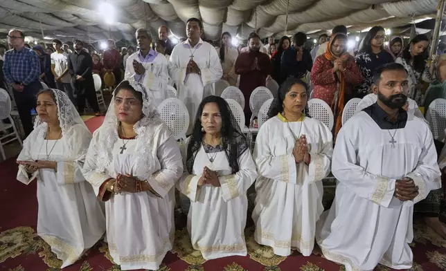 Pakistani Christians attend a midnight Easter Mass at St. Patrick's Cathedral Church, in Karachi, Pakistan, Sunday, April 20, 2025. (AP Photo/Fareed Khan)