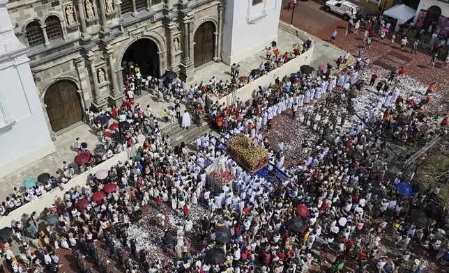 People attend an Easter procession in Panama City's Casco Viejo, Sunday, April 20, 2025. (AP Photo/Matias Delacroix)