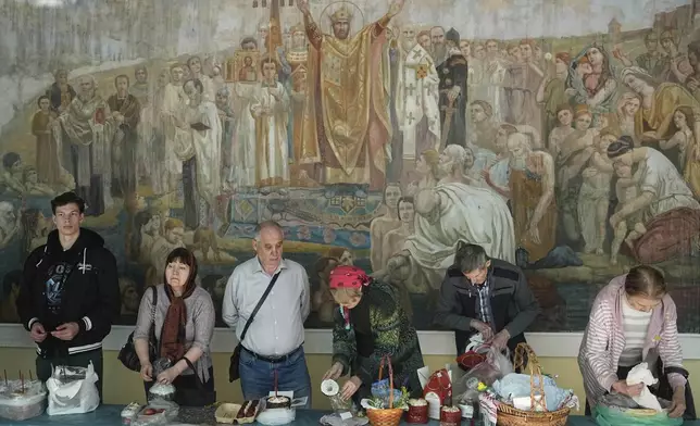 Believers attend blessing ceremony for traditional Easter cakes and painted eggs in preparation for Easter celebrations outside of the Epiphany Cathedral at Yelokhovo on Great Holy Saturday, in Moscow, Russia, Saturday, April 19, 2025. (AP Photo/Pavel Bednyakov)
