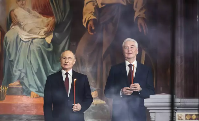 Russian President Vladimir Putin, left, and Moscow Mayor Sergei Sobyanin attend the Orthodox Easter service at Christ the Saviour Cathedral in Moscow, Russia, on Sunday, April 20, 2025. (Oleg Varov/Russian Orthodox Church Press Service via AP)