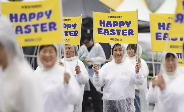 Participants march in the rain during the Easter parade in Seoul, South Korea, Saturday, April 19, 2025. (AP Photo/Lee Jin-man)