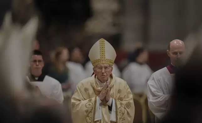 Dean of the College of Cardinals Giovanni Battista Re leads the Easter vigil inside St. Peter's Basilica at the Vatican, Saturday, April 19, 2025. (AP Photo/Alessandra Tarantino)