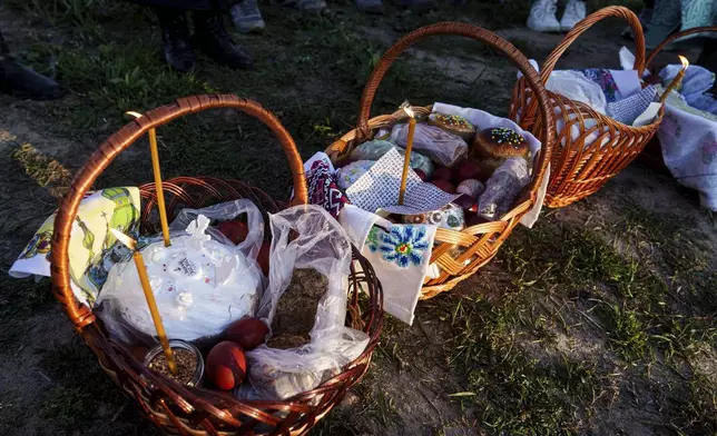 Easter baskets are seen during celebration of the Orthodox Easter in Krasne village, Ukraine, on Sunday, April 20, 2025. (AP Photo/Evgeniy Maloletka)