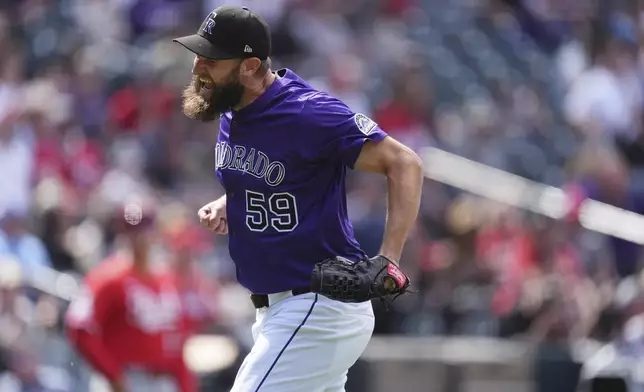 Colorado Rockies relief pitcher Jake Bird reacts after getting out of a bases-loaded jam by getting Cincinnati Reds' Gavin Lux to line out to end the top of the seventh inning of a baseball game Saturday, April 26, 2025, in Denver. (AP Photo/David Zalubowski)