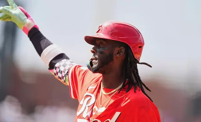 Cincinnati Reds' Elly De La Cruz gestures after hitting an RBI single off Colorado Rockies relief pitcher Tyler Kinley in the ninth inning of a baseball game Saturday, April 26, 2025, in Denver. (AP Photo/David Zalubowski)