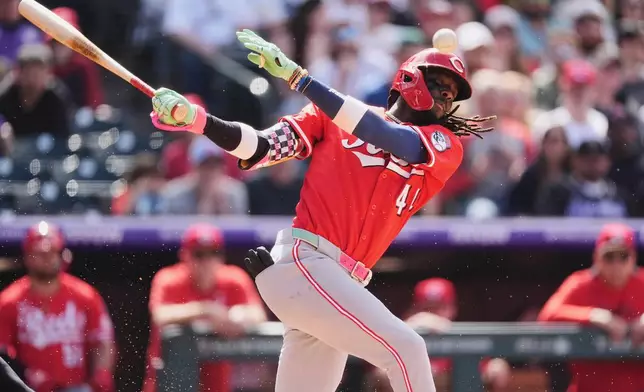 Cincinnati Reds' Elly De La Cruz fouls off a pitch from Colorado Rockies relief pitcher Tyler Kinley in the ninth inning of a baseball game Saturday, April 26, 2025, in Denver. (AP Photo/David Zalubowski)