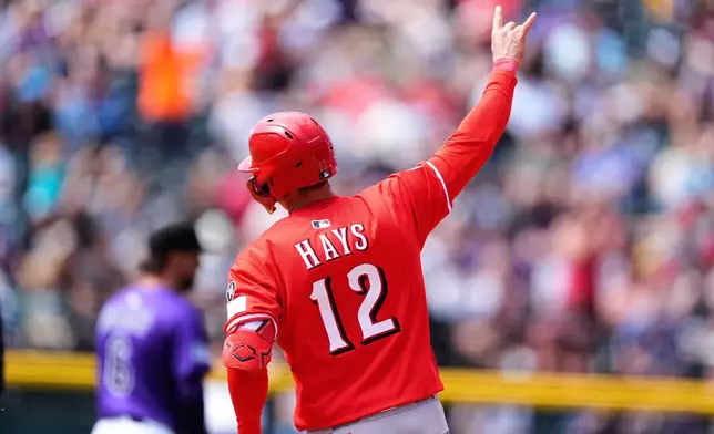 Cincinnati Reds' Austin Hays gestures as he circles the bases after hitting a solo home run off Colorado Rockies starting pitcher Antonio Senzatela in the sixth inning of a baseball game Saturday, April 26, 2025, in Denver. (AP Photo/David Zalubowski)
