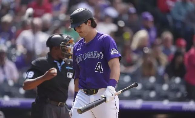 Colorado Rockies' Michael Toglia reacts after striking out against Cincinnati Reds relief pitcher Alexis Díaz to end the eighth inning of a baseball game Saturday, April 26, 2025, in Denver. (AP Photo/David Zalubowski)