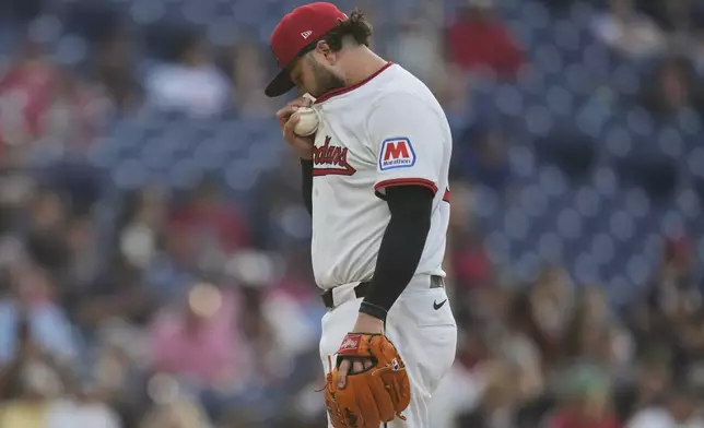 Cleveland Guardians relief pitcher Jakob Junis wipes his face in the fourth inning of a baseball game against the Minnesota Twins in Cleveland, Monday, April 28, 2025. (AP Photo/Sue Ogrocki)