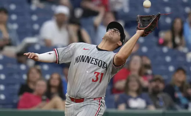 Minnesota Twins first baseman Jonah Bride (31) catches a fly ball hit for an out by Cleveland Guardians' Brayan Rocchio in the fifth inning of a baseball game in Cleveland, Monday, April 28, 2025. (AP Photo/Sue Ogrocki)