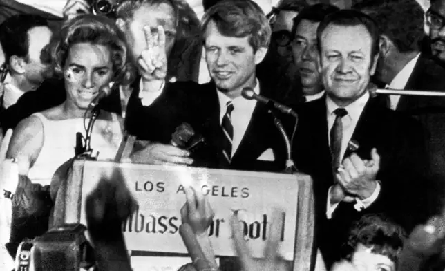 FILE - Sen. Robert F. Kennedy, D-N.Y., speaks to campaign workers, June 5, 1968, as his wife Ethel, left, and California campaign manager and speaker of the California Assembly, Jesse Unruh, look on, at the Ambassador Hotel in Los Angeles. (AP Photo)
