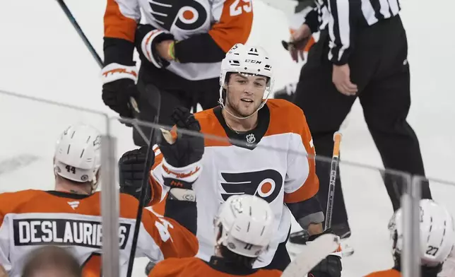 Philadelphia Flyers' Tyson Foerster (71) celebrates with teammates after scoring an empty-net goal during the third period of an NHL hockey game against the New York Rangers Wednesday, April 9, 2025, in New York. (AP Photo/Frank Franklin II)