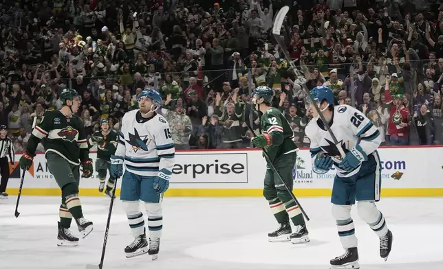 Minnesota Wild center Joel Eriksson Ek (14), left, celebrates toward left wing Matt Boldy (12) after scoring a goal during the third period of an NHL hockey game against the San Jose Sharks, Wednesday, April 9, 2025, in St. Paul, Minn. (AP Photo/Abbie Parr)