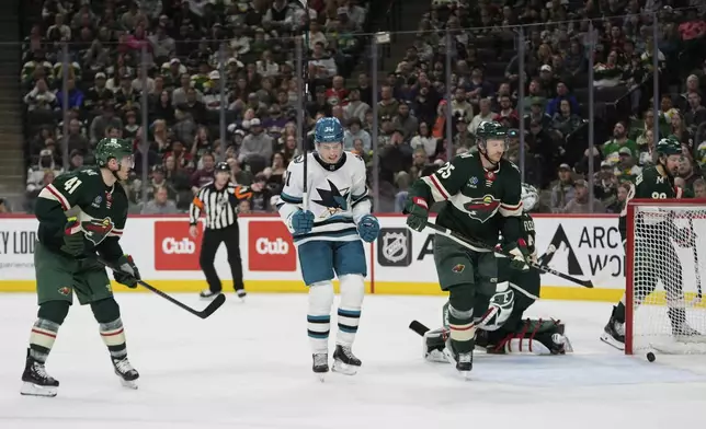 San Jose Sharks center Macklin Celebrini (71), middle, celebrates after scoring a goal during the second period of an NHL hockey game against the Minnesota Wild, Wednesday, April 9, 2025, in St. Paul, Minn. (AP Photo/Abbie Parr)
