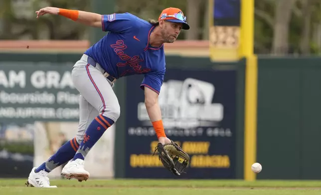 FILE - New York Mets second baseman Jeff McNeil handles a ground out by Miami Marlins' Kyle Stowers during the first inning of a spring training baseball game Wednesday, Feb. 26, 2025, in Jupiter, Fla. (AP Photo/Jeff Roberson,File)