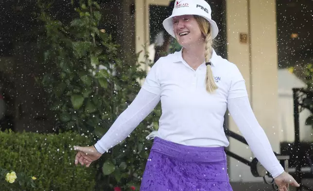 Ingrid Lindblad reacts while being sprayed with champagne after winning the LPGA JM Eagle LA Championship golf tournament at El Caballero Country Club, Sunday, April 20, 2025, in Los Angeles. (AP Photo/Jessie Alcheh)