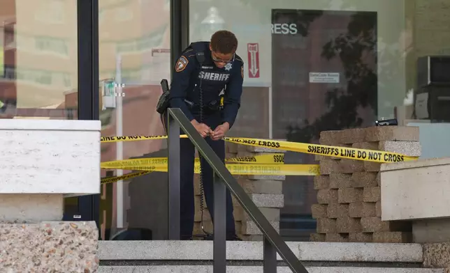 Law enforcement work outside the Family Law Center after a Harris County deputy was shot in Houston, Monday, April 21, 2025. (Yi-Chin Lee/Houston Chronicle via AP)