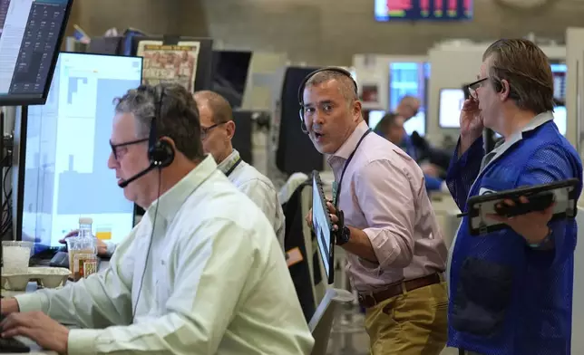 Traders work on the options floor at the New York Stock Exchange in New York, Monday, April 7, 2025. (AP Photo/Seth Wenig)