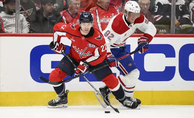 Montreal Canadiens right wing Patrik Laine (92) battles for the puck against Washington Capitals right wing Brandon Duhaime (22) in the second period of Game 1 of a first-round NHL hockey playoff series Monday, April 21, 2025, in Washington. (AP Photo/Nick Wass)