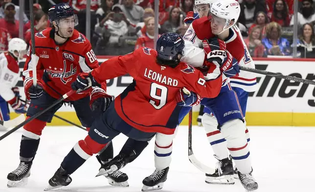 Montreal Canadiens defenseman Kaiden Guhle (21) brings down Washington Capitals right wing Ryan Leonard (9) in the first period of Game 1 of a first-round NHL hockey playoff series Monday, April 21, 2025, in Washington. (AP Photo/Nick Wass)