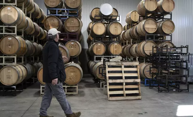 Scott Osborn, owner of Fox Run Vineyards, walks past wine barrels, Friday, March 21, 2025, in Penn Yan, N.Y. (Natasha Kaiser via AP)