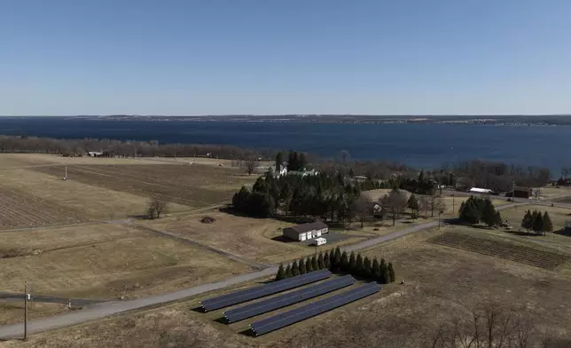 Solar panels operate at Fox Run Vineyards and Seneca Lake, Friday, March 21, 2025, in Penn Yan, N.Y. (Natasha Kaiser via AP)