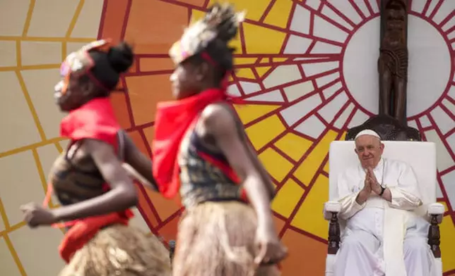 FILE - Pope Francis looks at traditional dancers performing at the Martyrs' Stadium In Kinshasa, Democratic Republic of Congo, Thursday, Feb. 2, 2023. (AP Photo/Gregorio Borgia, File)