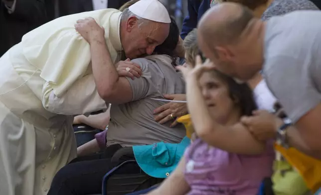 FILE - Pope Francis blesses sick and disabled people at the end of a pro-life Mass in St. Peter's Square, at the Vatican, Sunday, June 16, 2013. (AP Photo/Andrew Medichini, File)