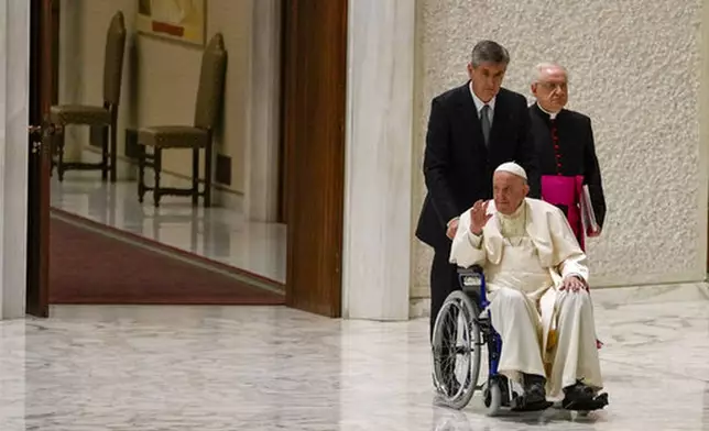 FILE - Pope Francis arrives in a wheelchair to attend an audience with nuns and religious superiors in the Paul VI Hall at The Vatican, Thursday, May 5, 2022. (AP Photo/Alessandra Tarantino, File)