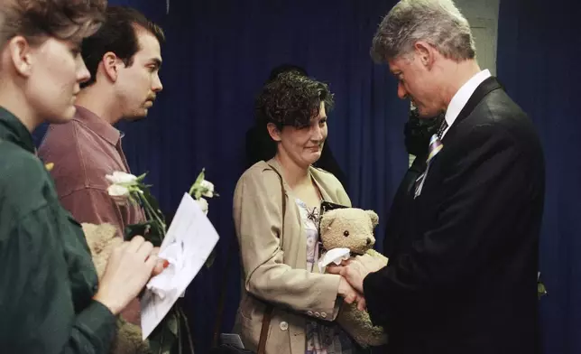 FILE - Aren Almon greets President Bill Clinton after a prayer service for the victims of the deadly truck bomb attack in Oklahoma City on April 23, 1995. (AP Photo/Pat Sullivan, File)