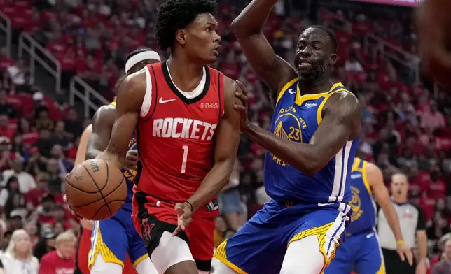 Golden State Warriors forward Draymond Green (23) defends against Houston Rockets guard Amen Thompson (1) during the first half of Game 2 of an NBA basketball first-round playoff series against the Houston Rockets in Houston, Wednesday, April 23, 2025. (AP Photo/Karen Warren)