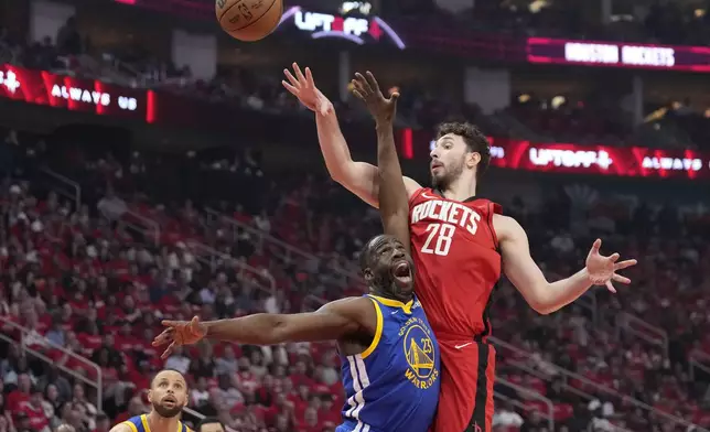 Houston Rockets center Alperen Sengun (28) shoots over Golden State Warriors forward Draymond Green (23) during the first half of Game 2 of an NBA basketball first-round playoff series against the Houston Rockets in Houston, Wednesday, April 23, 2025. (AP Photo/Karen Warren)