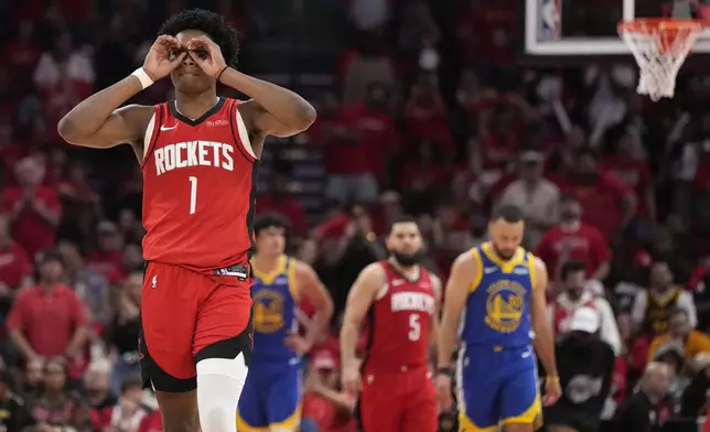 Houston Rockets guard Amen Thompson (1) reacts after dunking the ball against the Golden State Warriors during the second half of Game 2 of an NBA basketball first-round playoff series against the Houston Rockets in Houston, Wednesday, April 23, 2025. (AP Photo/Karen Warren)