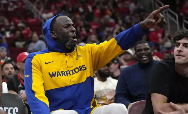 Golden State Warriors' Draymond Green yells at Houston Rockets fans from the bench after leaving the game during the second half of Game 2 of an NBA basketball first-round playoff series against the Houston Rockets in Houston, Wednesday, April 23, 2025. (AP Photo/Karen Warren)