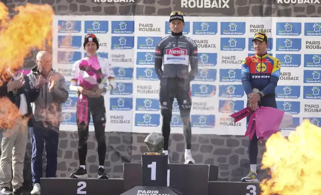 Second placed, Tadej Pogacar, of Slovenia, winner Mathieu van der Poel, of the Netherlands, and third placed Mads Pedersen, of Denmark, pose on the podium of the Paris-Roubaix cycling race in Roubaix, France, Sunday, April 13, 2025. (AP Photo/Thibault Camus)