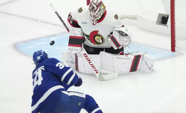 Ottawa Senators goaltender Linus Ullmark (35) makes a save against Toronto Maple Leafs' Auston Matthews (34) during the second period of an NHL hockey playoff game in Toronto on Tuesday, April 29, 2025. (Nathan Denette/The Canadian Press via AP)