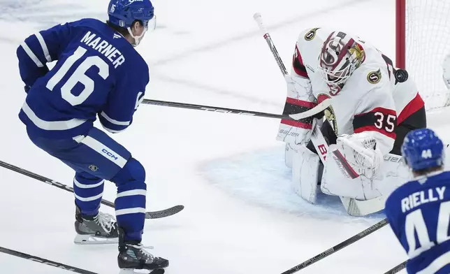 Ottawa Senators goaltender Linus Ullmark (35) makes a save against Toronto Maple Leafs' Mitch Marner (16) during the second period of an NHL hockey playoff game in Toronto on Tuesday, April 29, 2025. (Nathan Denette/The Canadian Press via AP)