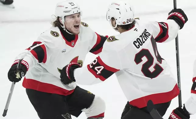Ottawa Senators' Dylan Cozens (24) celebrates his short handed goal with teammate Adam Gaudette (81) during third period NHL playoff action in Toronto on Tuesday, April 29, 2025. (Nathan Denette/The Canadian Press via AP)