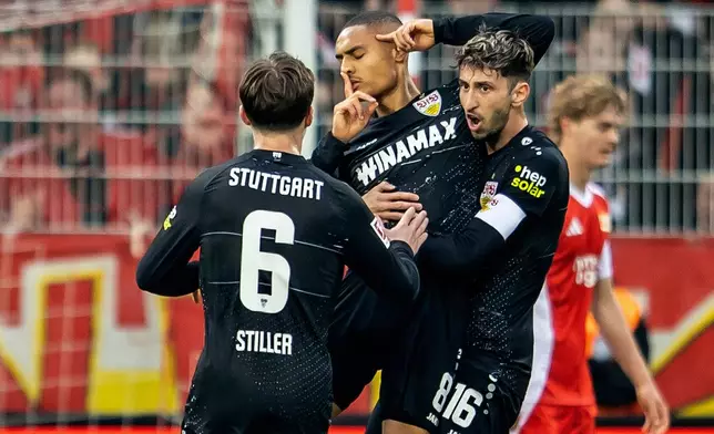 Stuttgart's Enzo Millot, center, celebrates scoring with teammates during the Bundesliga soccer match between 1. FC Union Berlin and VfB Stuttgart in Berlin, Saturday April 19, 2025. (Andreas Gora/dpa via AP)
