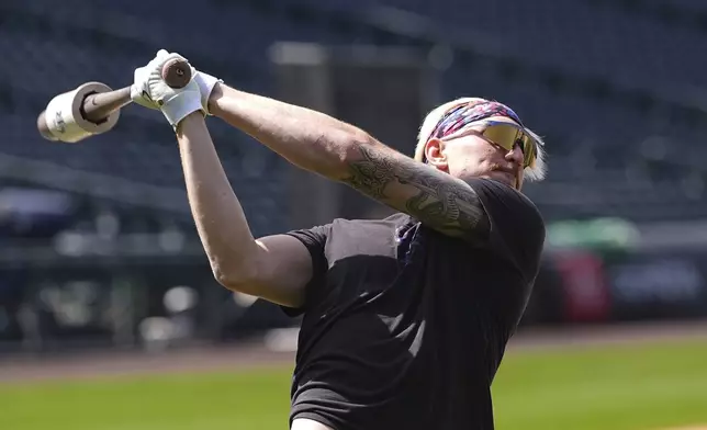 Colorado Rockies right field prospect Zac Veen, who was called up from Triple-A affiliate Albuquerque, warms up before appearing in his first Major League Baseball game against the Milwaukee Brewers, Tuesday, April 8, 2025, in Denver. (AP Photo/David Zalubowski)