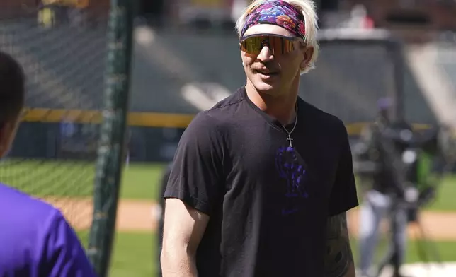 Colorado Rockies right field prospect Zac Veen, who was called up from Triple-A affiliate Albuquerque, warms up before appearing in his first Major League Baseball game against the Milwaukee Brewers, Tuesday, April 8, 2025, in Denver. (AP Photo/David Zalubowski)