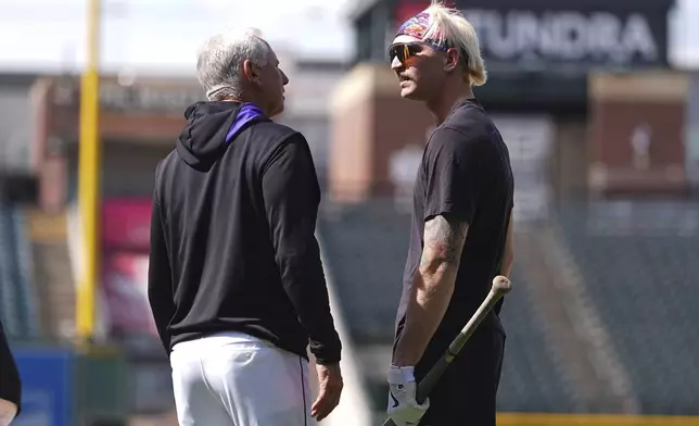 Colorado Rockies right field prospect Zac Veen, right, who was called up from Triple-A affiliate Albuquerque, chats with manager Bud Black before appearing appearing in his first Major League Baseball game against the Milwaukee Brewers, Tuesday, April 8, 2025, in Denver. (AP Photo/David Zalubowski)