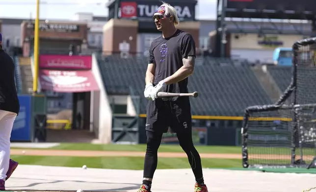Colorado Rockies right field prospect Zac Veen, who was called up from Triple-A affiliate Albuquerque, warms up before appearing in his first Major League Baseball game against the Milwaukee Brewers, Tuesday, April 8, 2025, in Denver. (AP Photo/David Zalubowski)