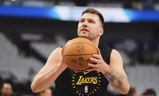 Los Angeles Lakers' Luka Doncic warms up before an NBA basketball game against the Dallas Mavericks in Dallas, Wednesday, April 9, 2025. (AP Photo/LM Otero)